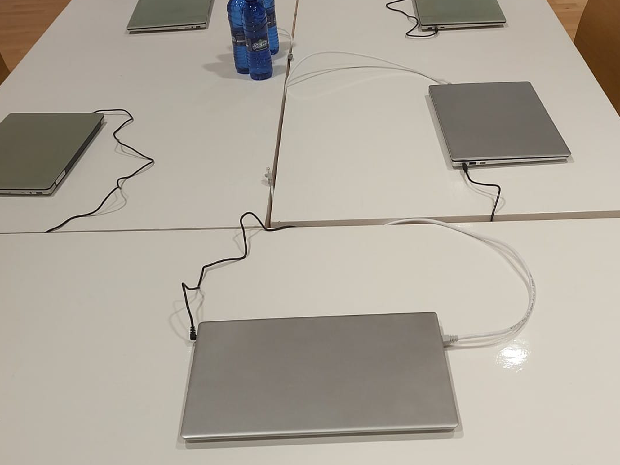 A group of laptops connected to a wire